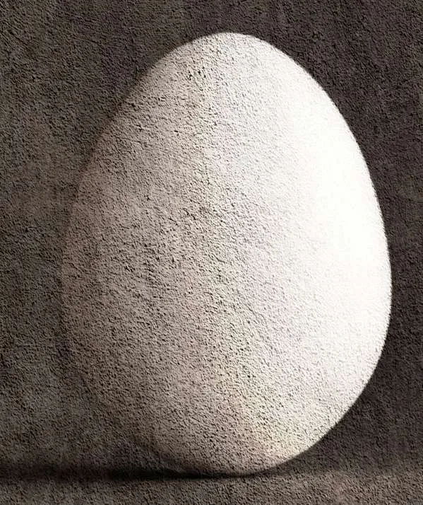 Huevo blanco de textura rugosa sobre fondo gris